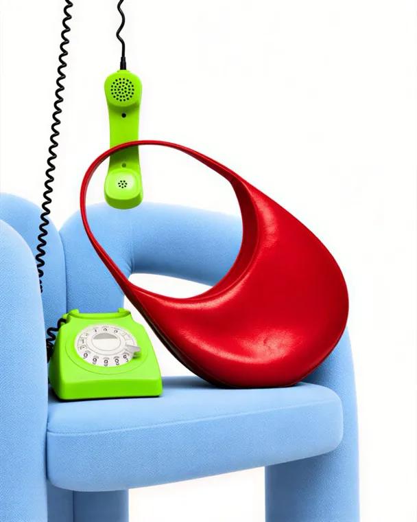 Editorial: a red bag on a blue chair with a green phone